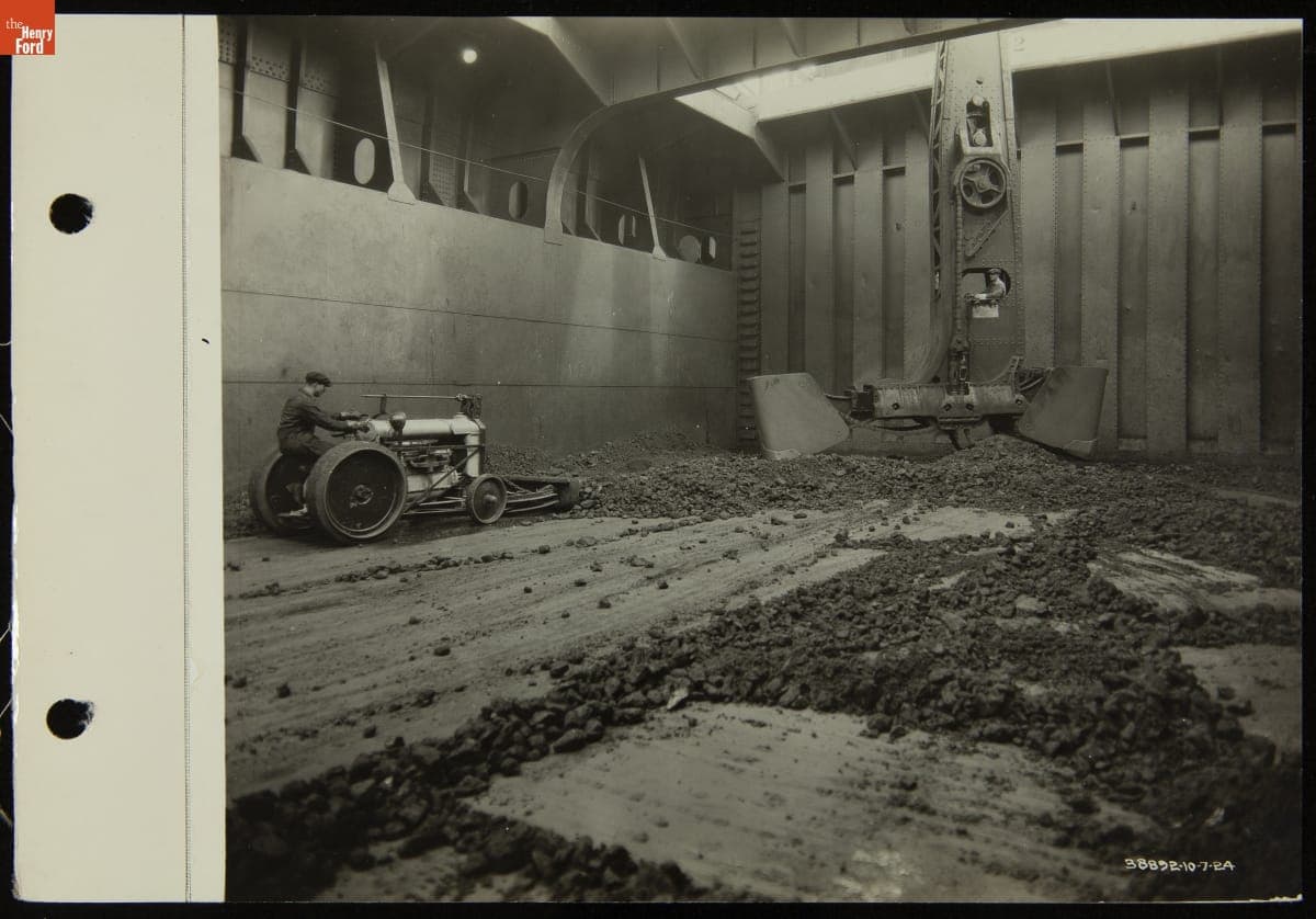 Employee Driving Ore Tractor inside Hull of Ford Freighter "Henry Ford II" at the Ford Rouge Plant, October 7, 1924