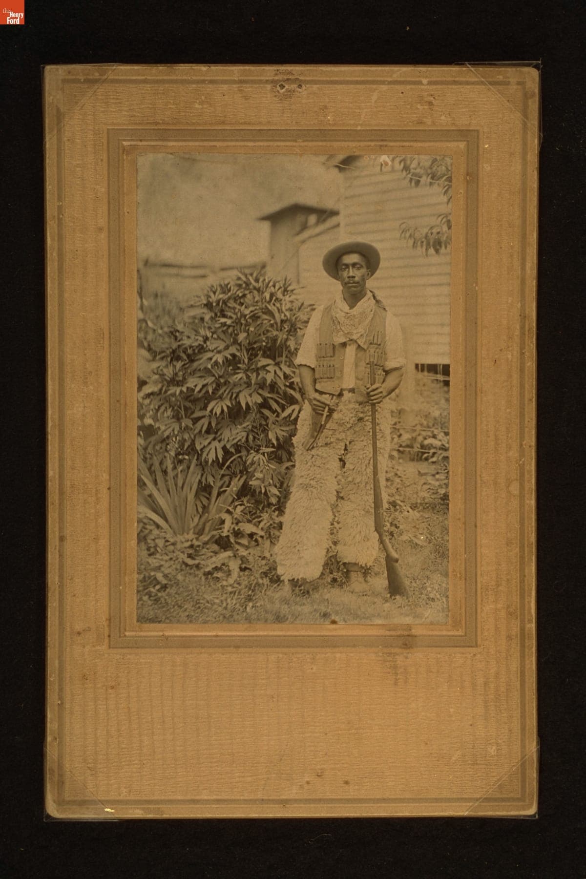 Cowboy Holding a Rifle and a Cigar, circa 1910