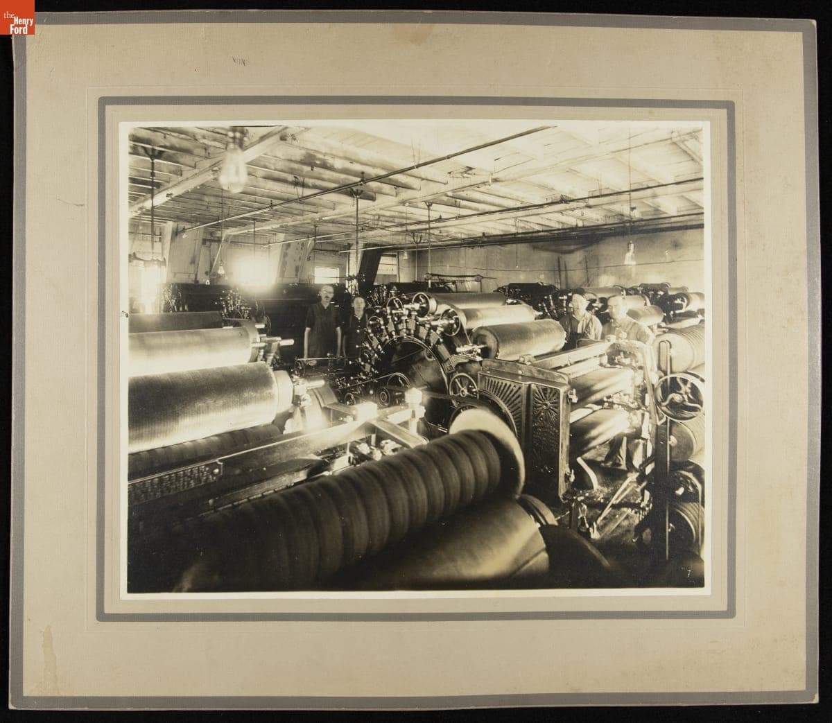 Workers in a Textile Mill Standing next to Machinery, circa 1910