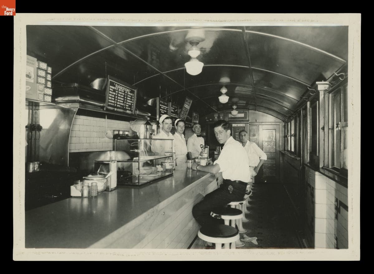 Loyal Spaulding, Harold Huff, and J. Edward Parks behind the Counter at Art's Filling Station, Waterville, Maine, circa 1930
