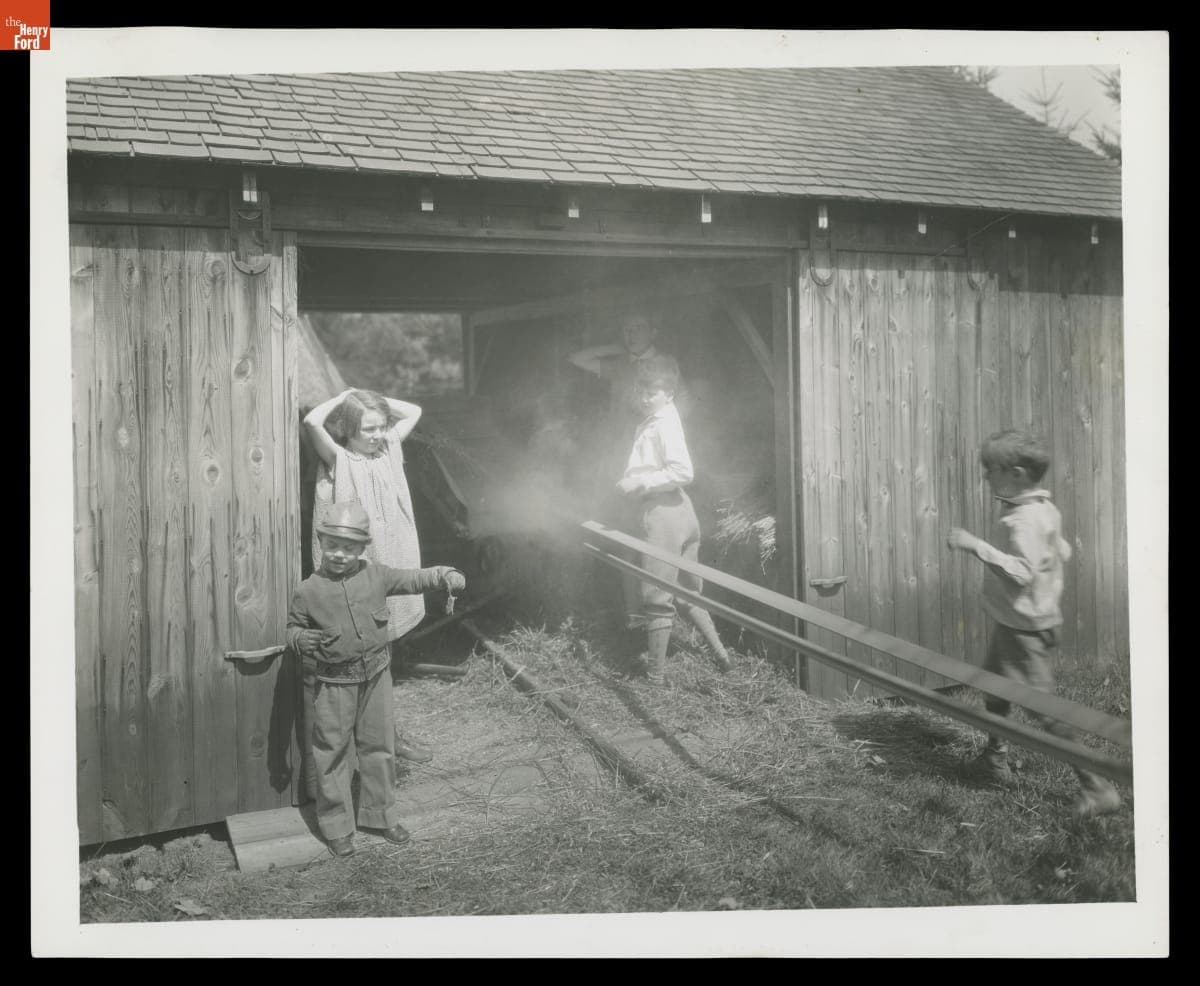 Henry Ford II Feeding Grain into the Hy-Ben-Jo-Bill Miniature Thresher-Separator, 1927