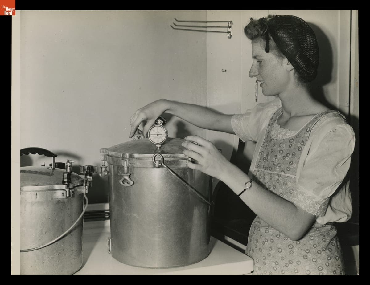 Macon (Michigan) High School Student Marjorie Korth Tightens Pressure Cooker Lid after Filling it with Jars of Beets, August 1943