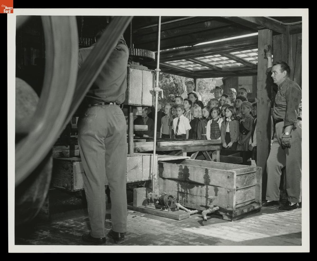 Crowd Watches Dick Sikorski and Sherman Garrison Operate the Cider Press at Greenfield Village Cider Mill, October 1967