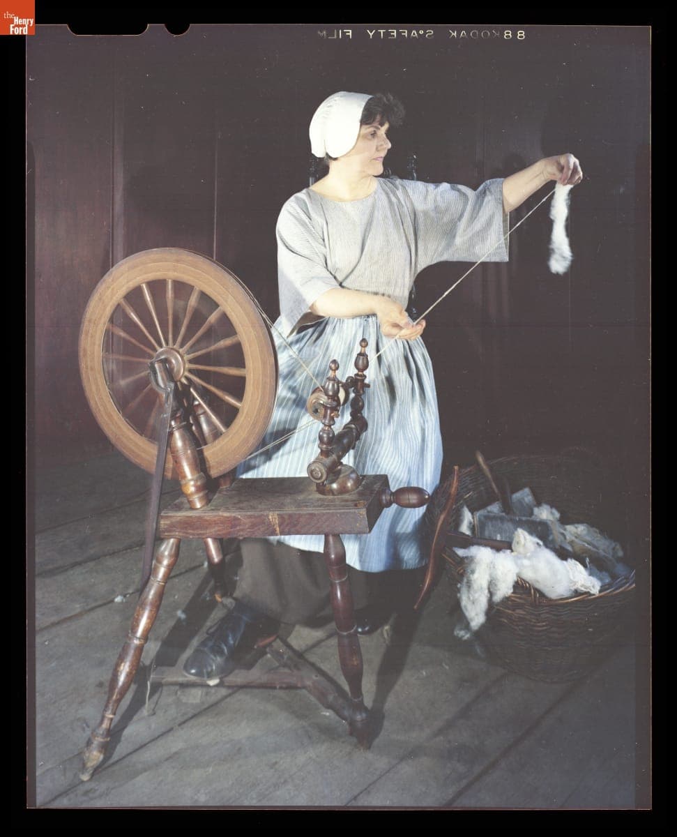 Presenter Shirley Schwarchoff Using a Spinning Wheel in Daggett Farmhouse in Greenfield Village, July 1983
