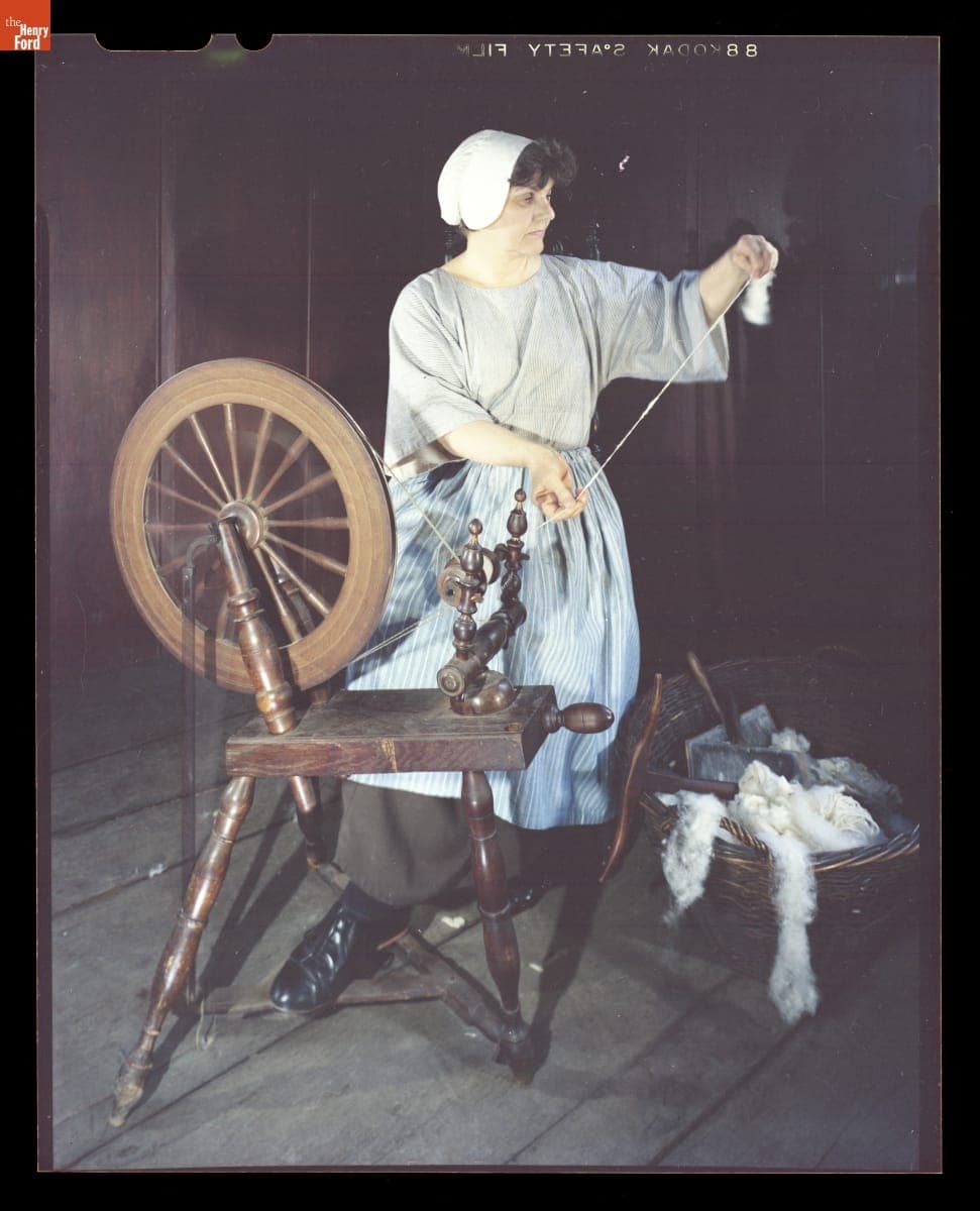 Presenter Shirley Schwarchoff Using a Spinning Wheel in Daggett Farmhouse in Greenfield Village, July 1983