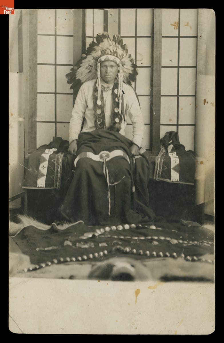 Young Indigenous Man Wearing Traditional War Bonnet