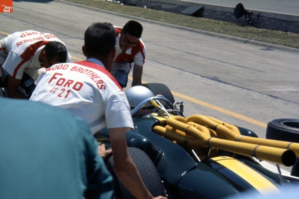 Wood Brothers Racing Team Working on Lotus 38 Racecar during Pit Stop, Indianapolis 500, Indianapolis, Indiana, May 31, 1965