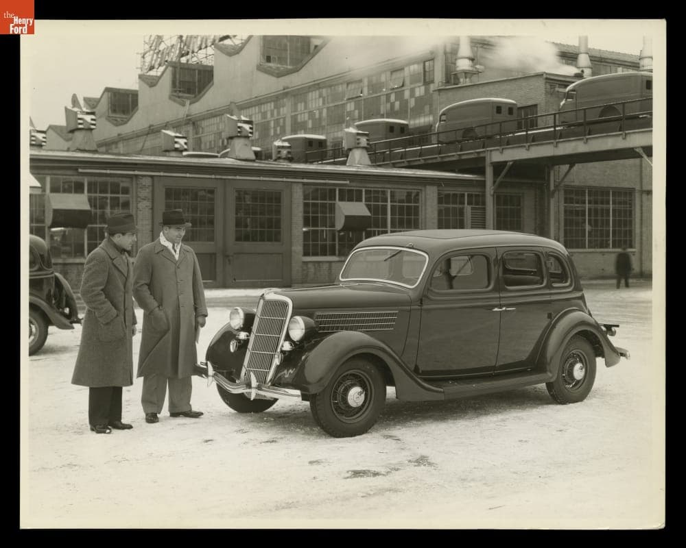 Detroit Lions Football Player George Christensen (right) with a 1935 Ford V-8 Fordor Sedan, December 1934