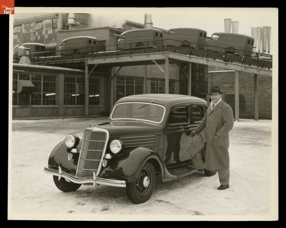Detroit Lions Football Player George Christensen with a 1935 Ford V-8 Fordor Sedan, December 1934