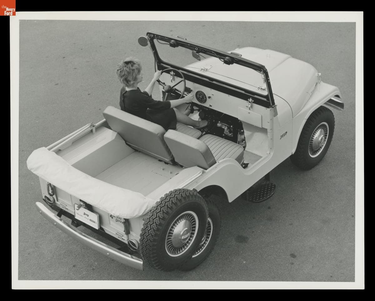 Aerial View of a Woman Driving a 1965 Kaiser Jeep