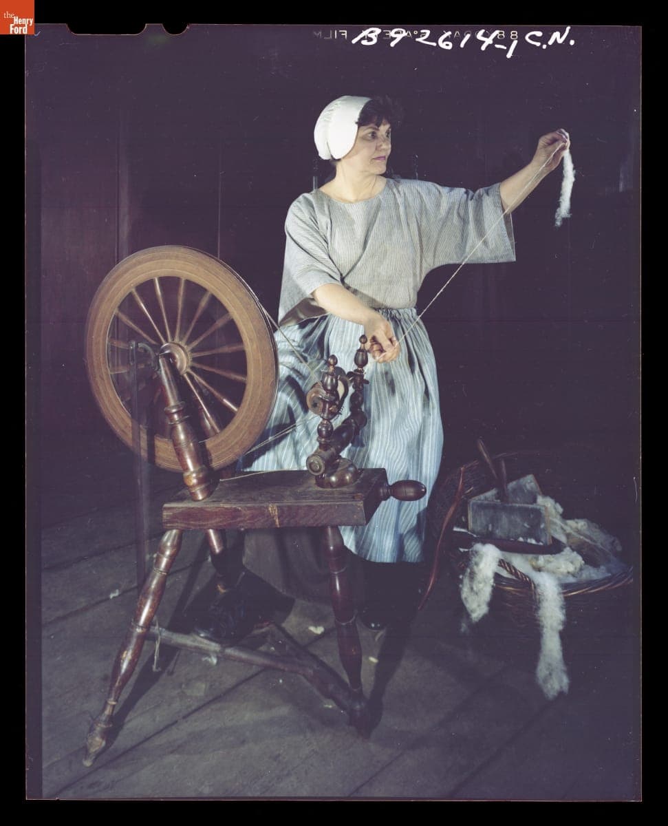 Presenter Shirley Schwarchoff Using a Spinning Wheel in Daggett Farmhouse in Greenfield Village, July 1983