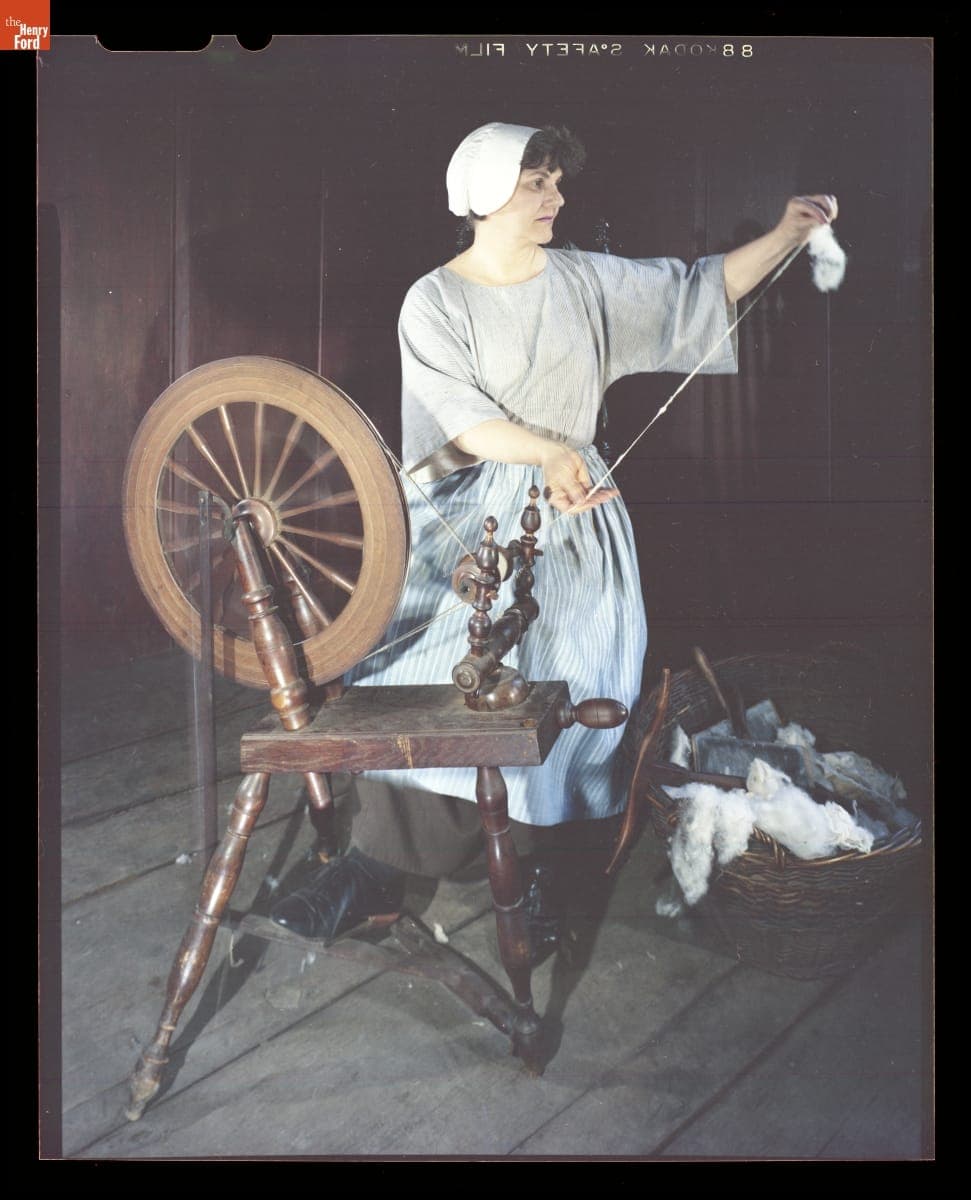 Presenter Shirley Schwarchoff Using a Spinning Wheel in Daggett Farmhouse in Greenfield Village, July 1983