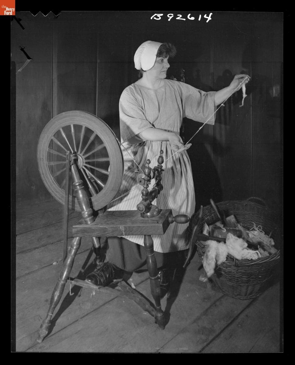 Presenter Shirley Schwarchoff Using a Spinning Wheel in Daggett Farmhouse in Greenfield Village, July 1983