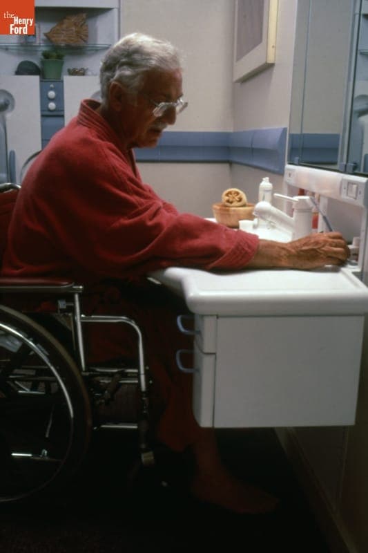 Man in Wheelchair Using MetaForm Adjustable Bathroom Sink, circa 1987