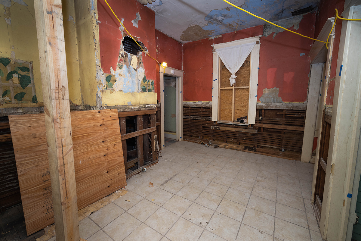 Wall treatments went from paint to wallpaper and back again. “Ghosting” on the wall revealed placement of objects like the range hood and a cupboard.