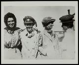 Four women, some wearing motoring coats and hats