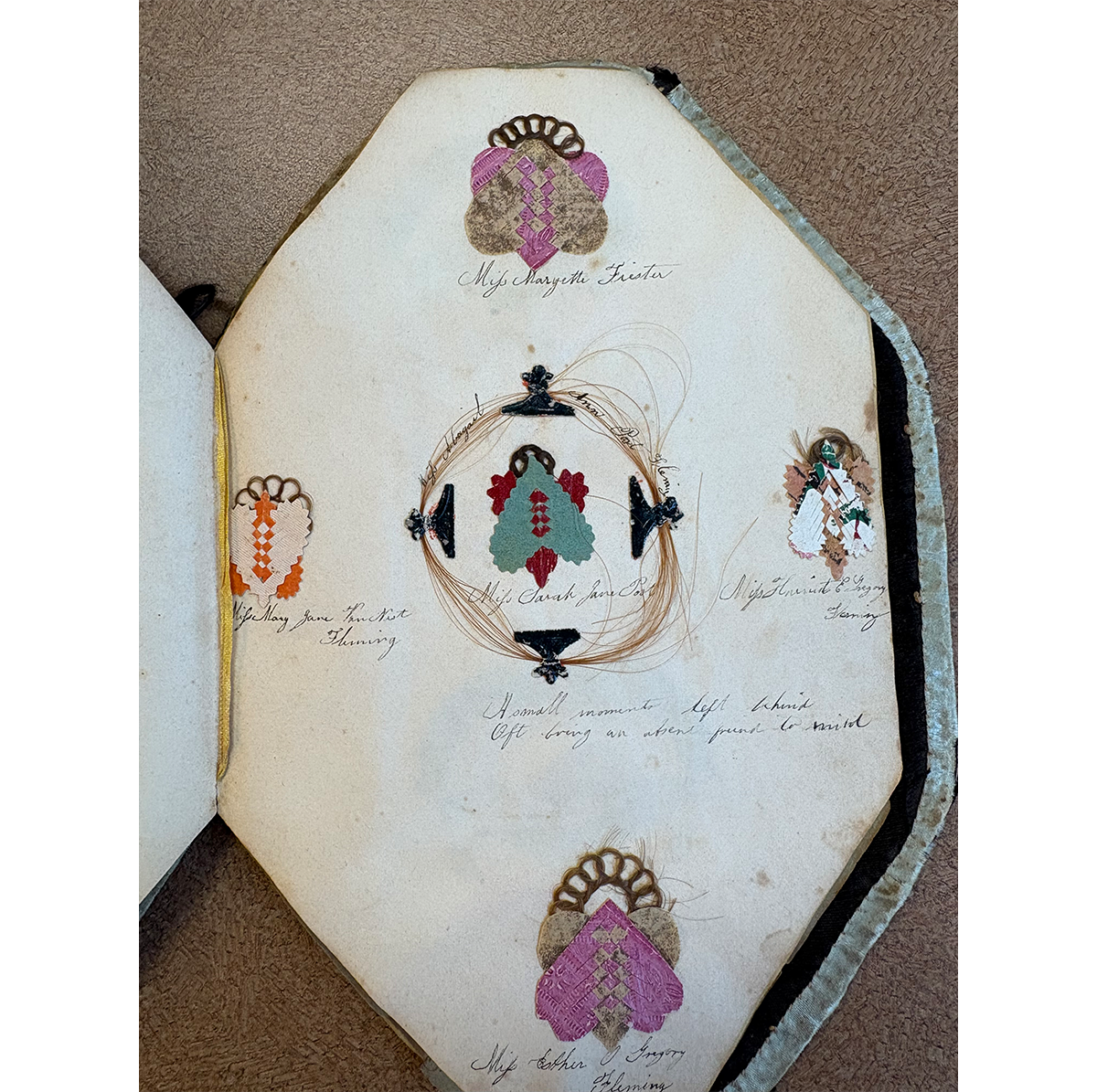 Pages depicting different colored woven hearts in Smith Album, Acc. 38.509.1 / Photo by Staff of The Henry Ford 