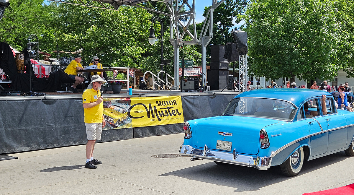 Historians Roger Wojtkowicz, Jim Wagner and John Wagner provide commentary on a 1956 Chevrolet during pass-in-review.