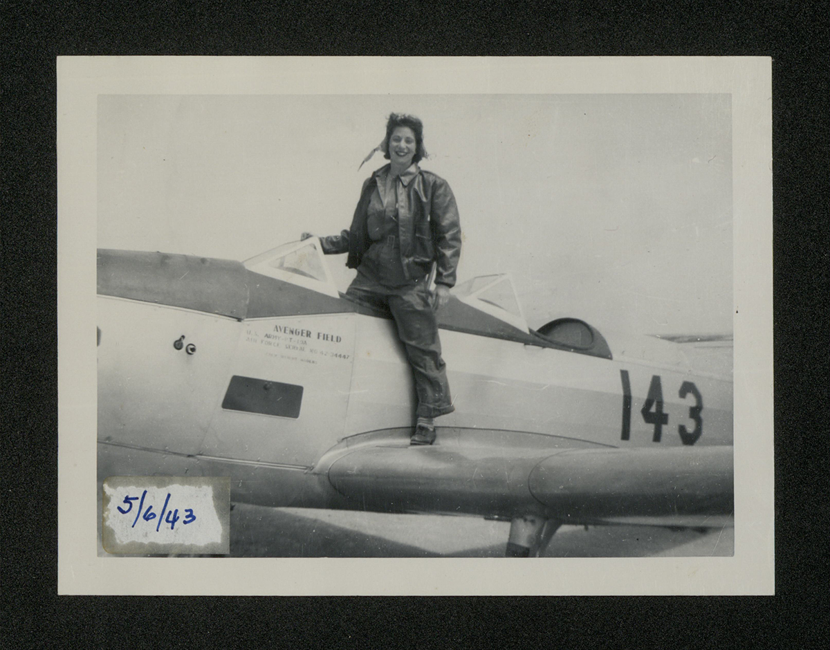 Ruth Westheimer steps out of a Fairchild PT-19A primary trainer aircraft at Avenger Field