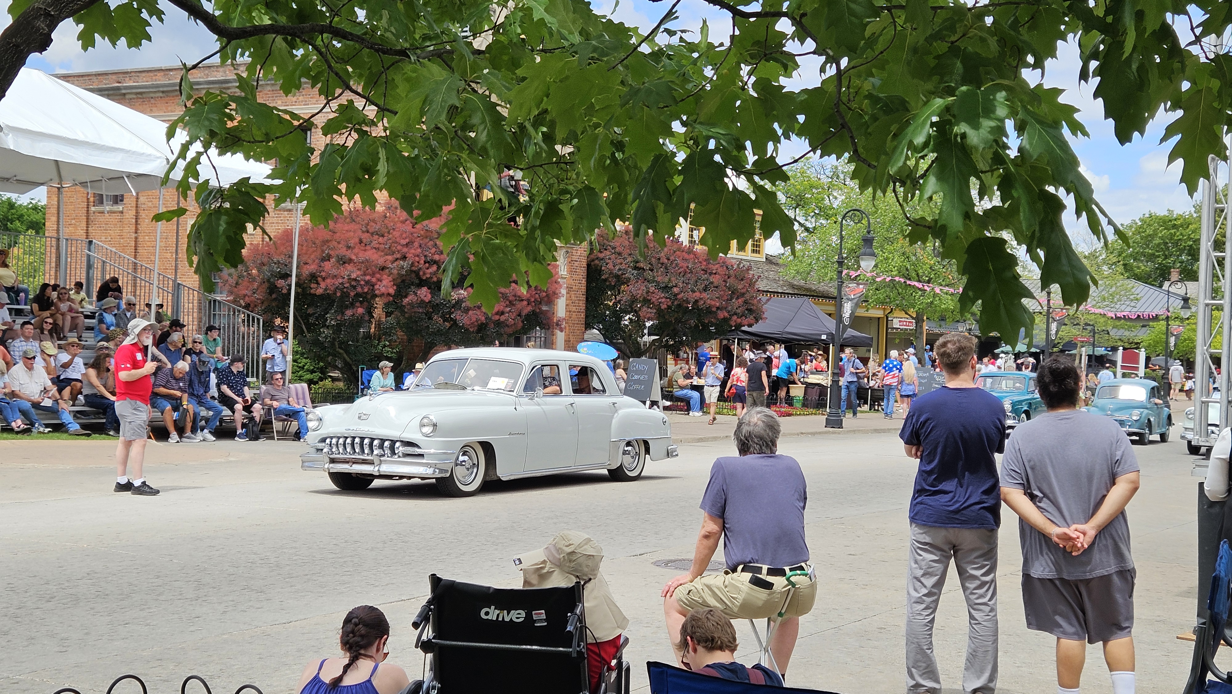20260620_144418 A 1951 DeSoto Custom participating in a pass-in-review vehicle presentation during Motor Muster 2026 at Greenfield Village.