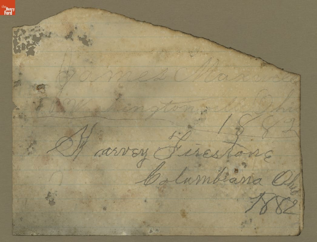 Torn scrap of lined paper with cursive handwriting on it