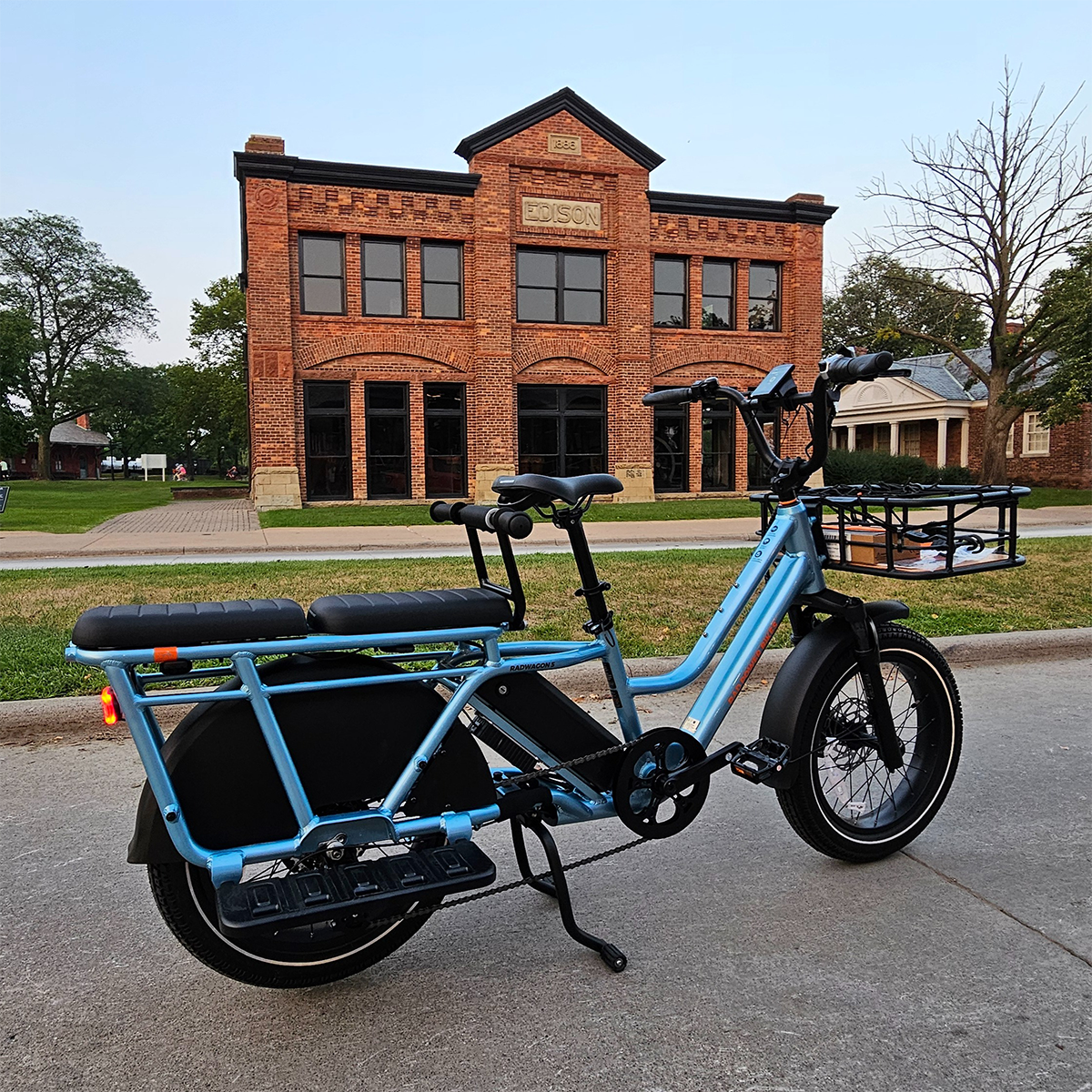 edison-bike a blue bicycle in front of a brick building