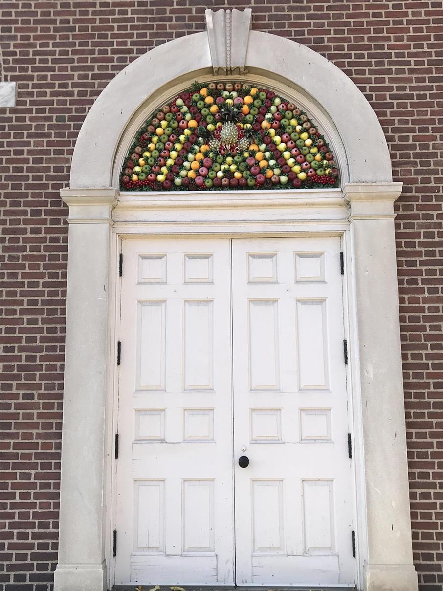 Della Robbia decorations on the façade of Henry Ford Museum Brick wall with large white double doors topped by an arch of fruit