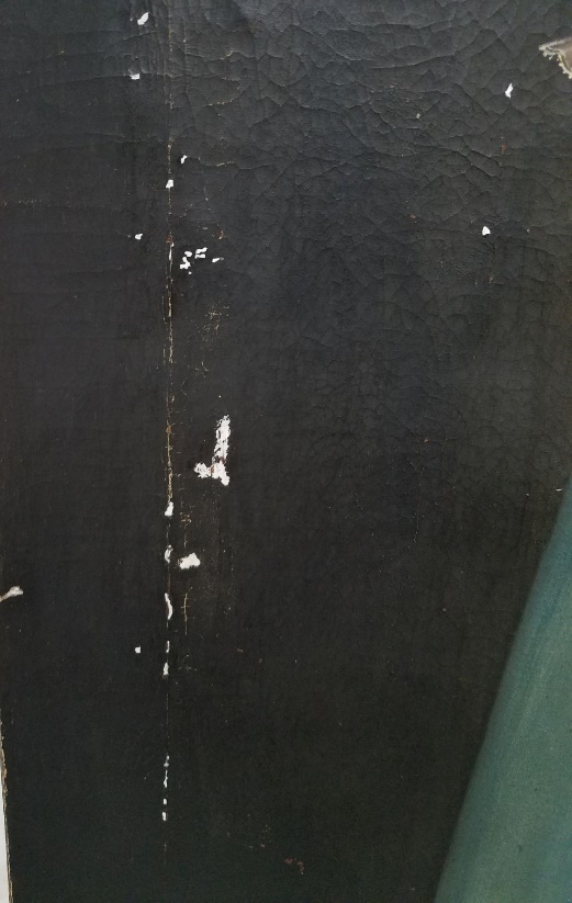 Close up of black paint showing white chips