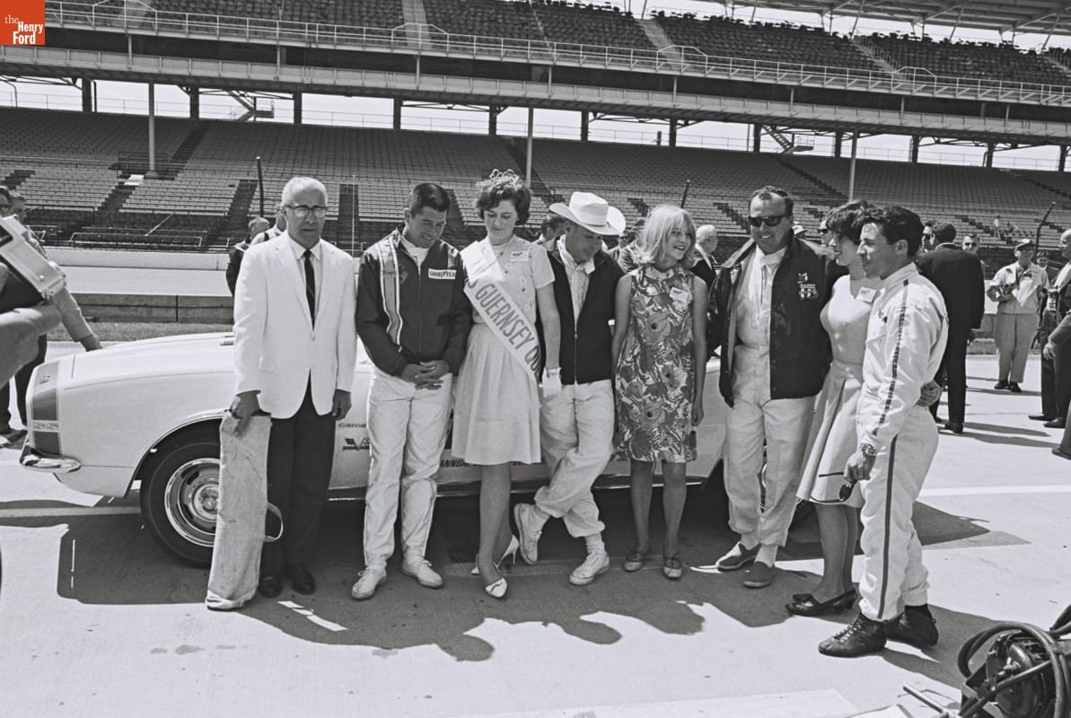 Roger McCluskey, Lloyd Ruby, A.J. Foyt and Mario Andretti posing with the Guersney Queen at the Indy 500 1967.
