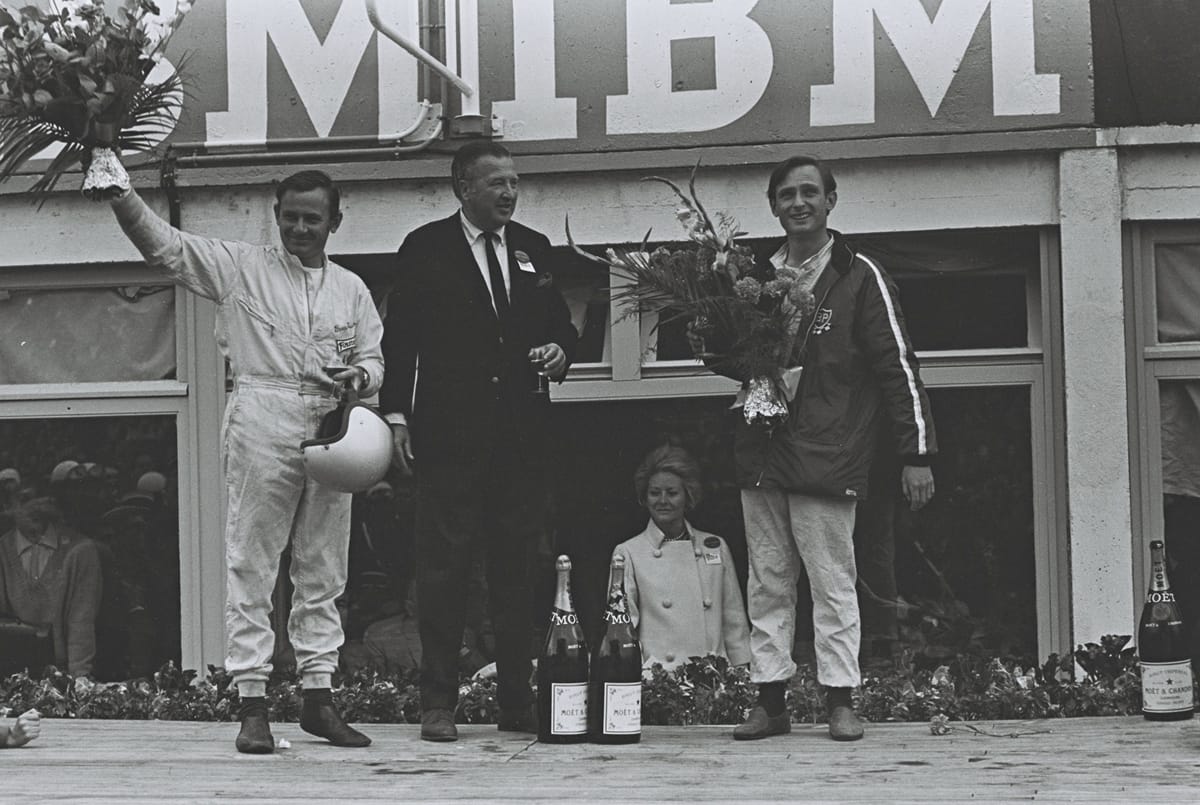 Henry Ford II celebrated with drivers Bruce McLaren (left) and Chris Armon (right) after their victory at Le Mans in 1966.
