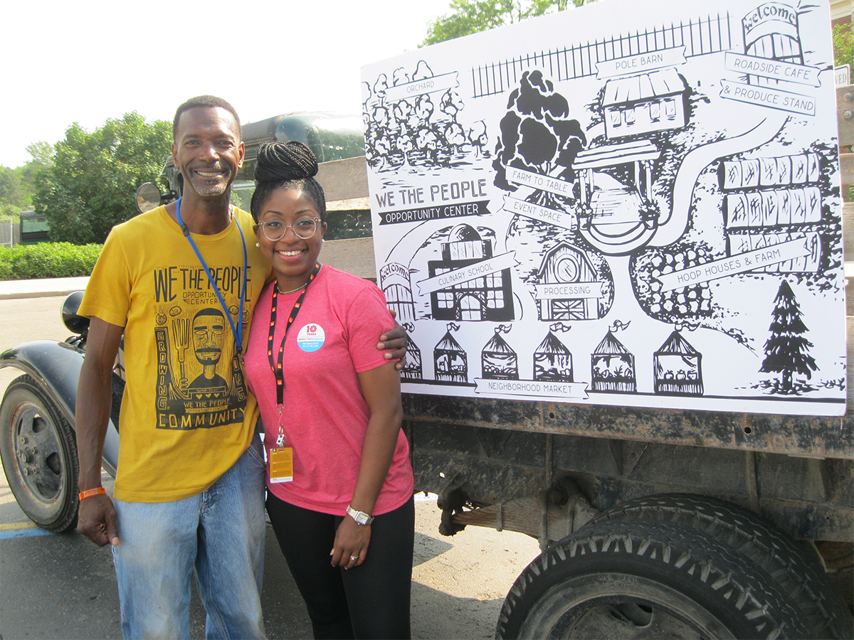 Melvin Parson and Anita Davis posing next to a tailer