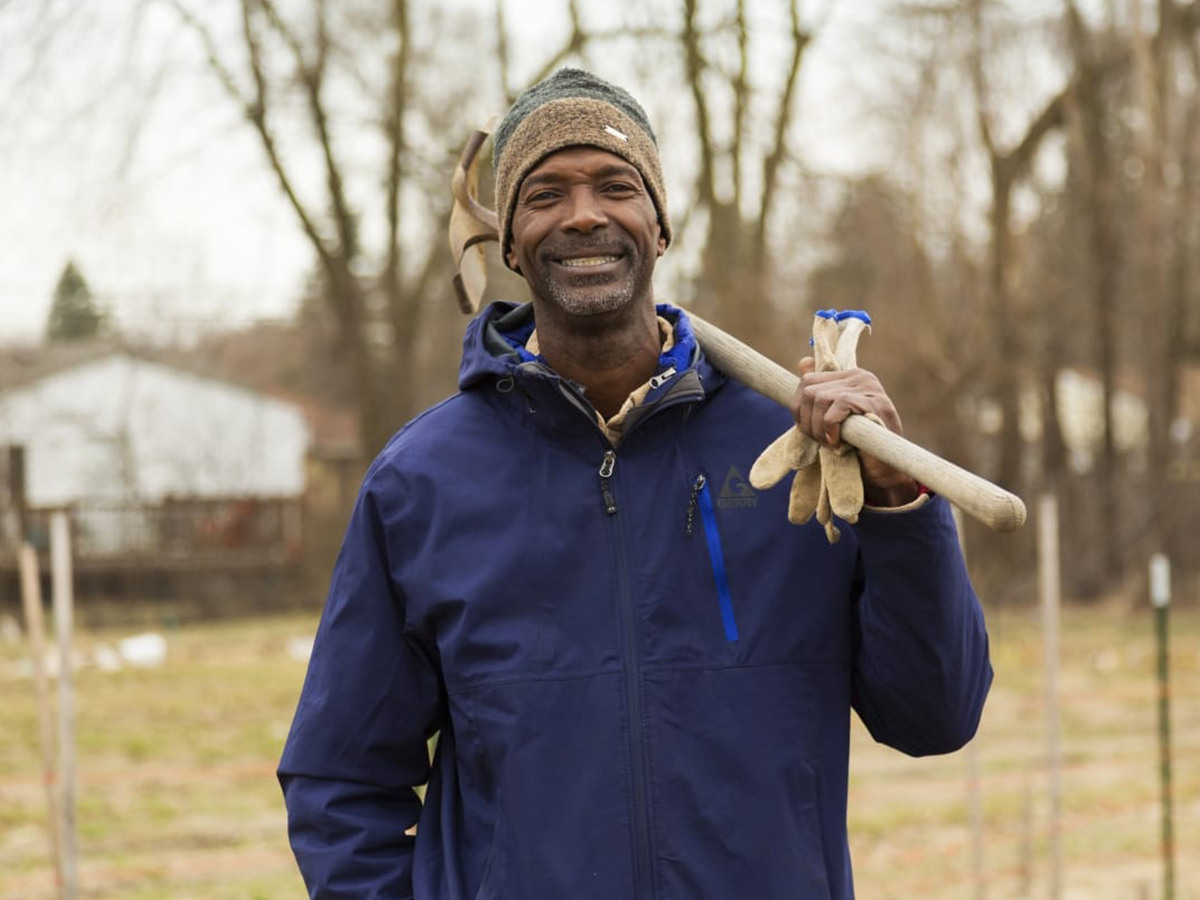 Melvin Parson posing with a shovel over his shoulder