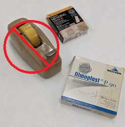 Tape dispenser with red "do not use" symbol over it, plus two boxes