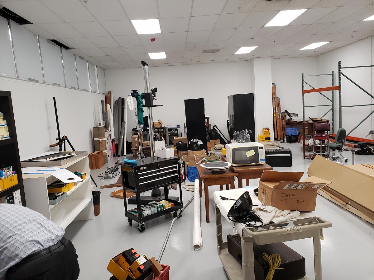 Cluttered room filled with carts, furniture, and other items