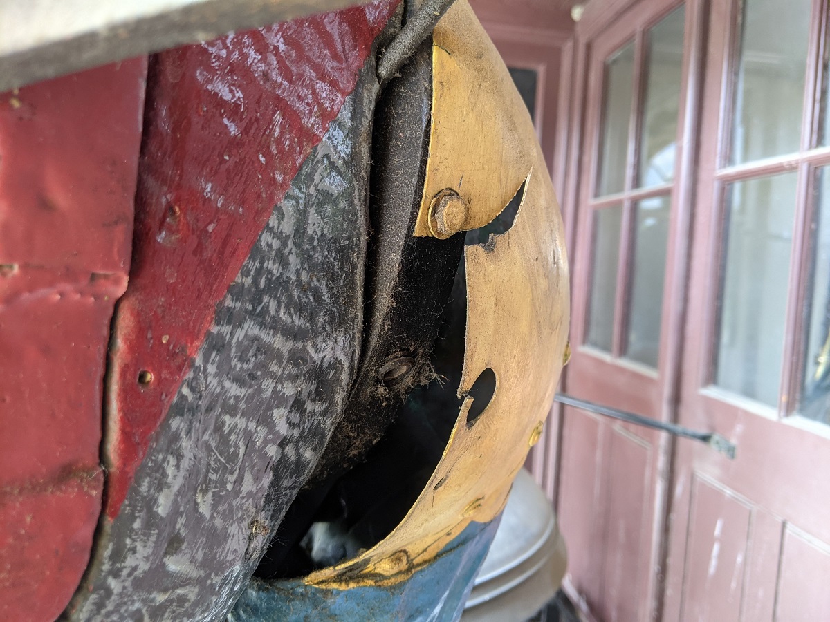 Recorded damage of Magog’s chiming arm Close-up of shoulder of figure in different colors and textures, one portion damaged