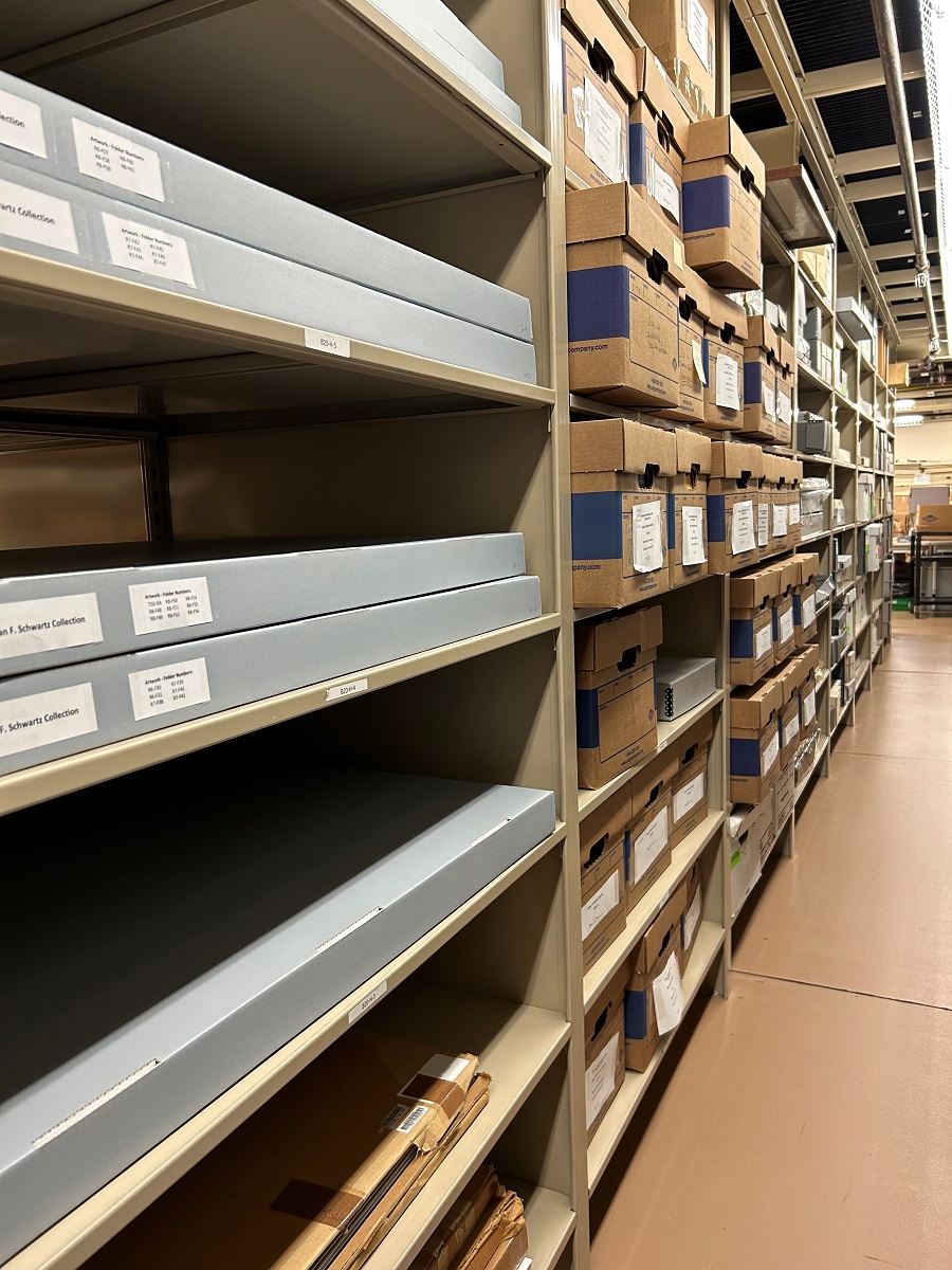 Shelving in the archives at The Henry Ford filled with Lillian Schwartz material Shelves stretching into the distance filled with a variety of archival boxes