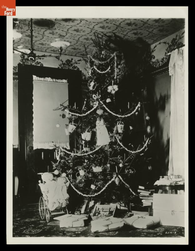 Decorated Christmas tree in corner of room with wrapped and unwrapped items underneath