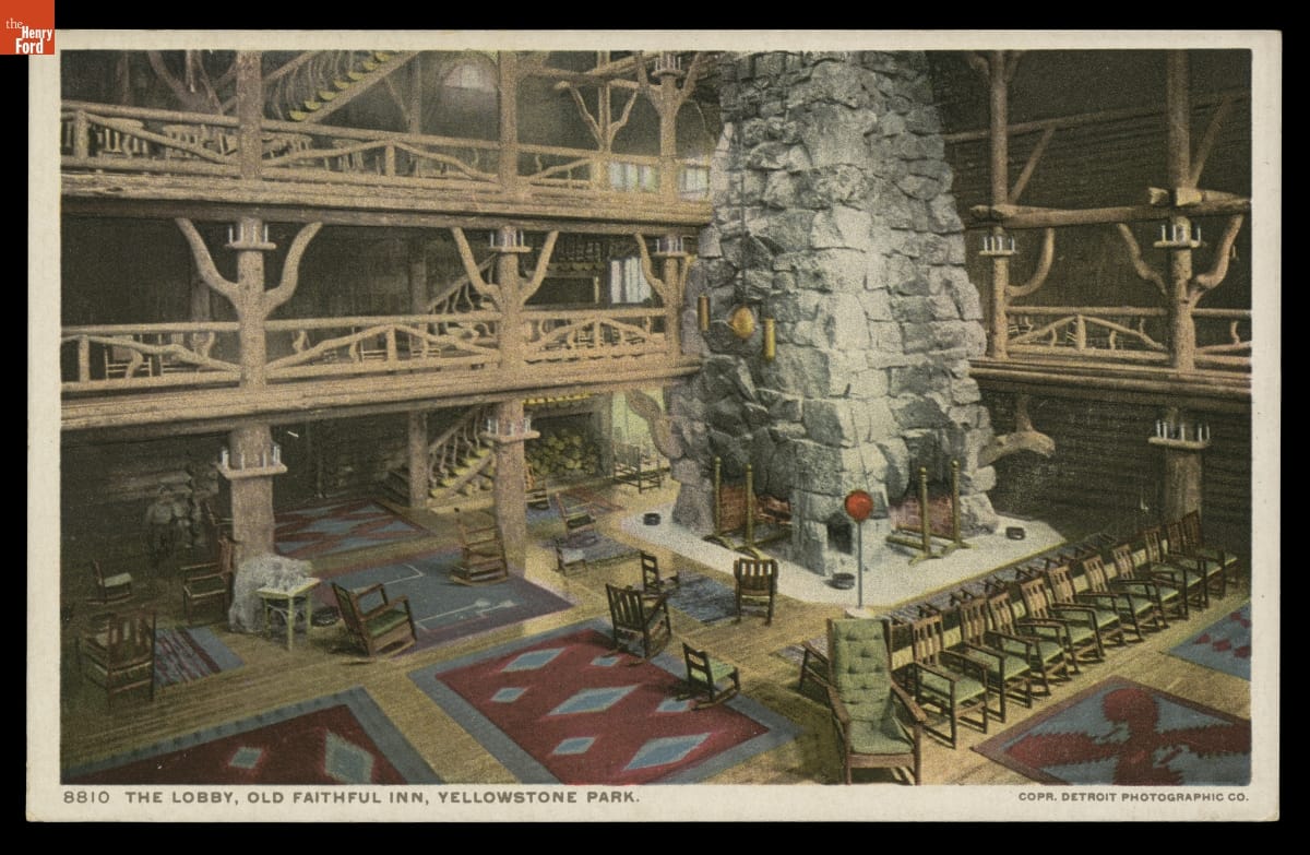 Postcard of large rustic space with interior balconies around perimeter and multi-story stone fireplace; also contains text