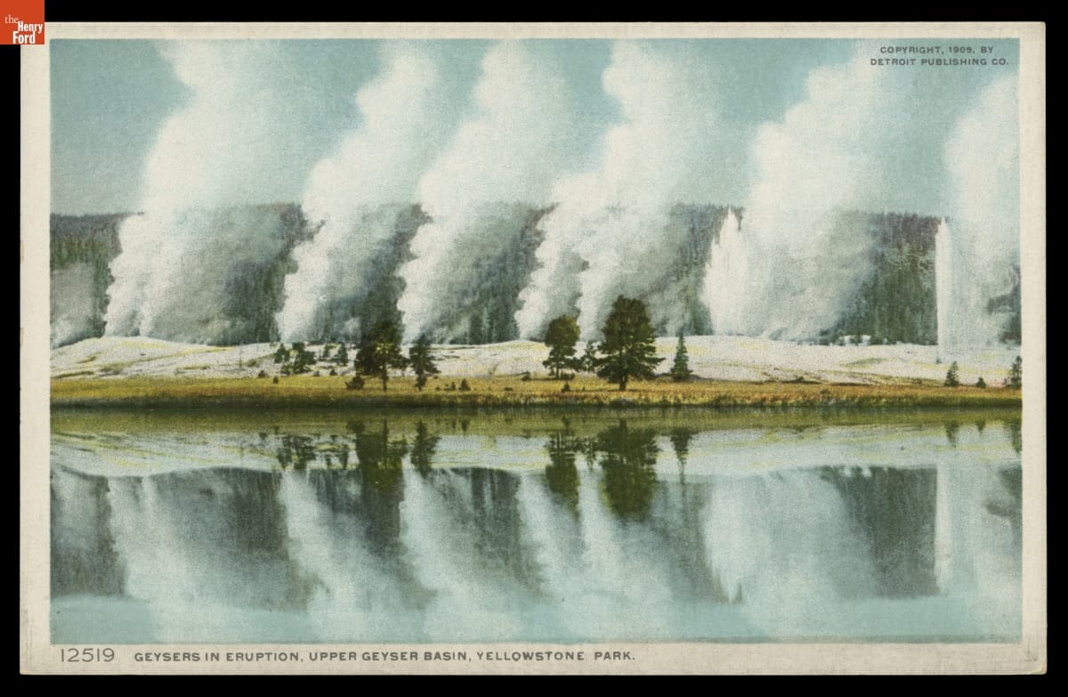 Geysers in Eruption, Upper Geyser Basin, Yellowstone Park, 1908-1909 Postcard with text and image of geysers erupting with hills in the background and a lake in the foreground