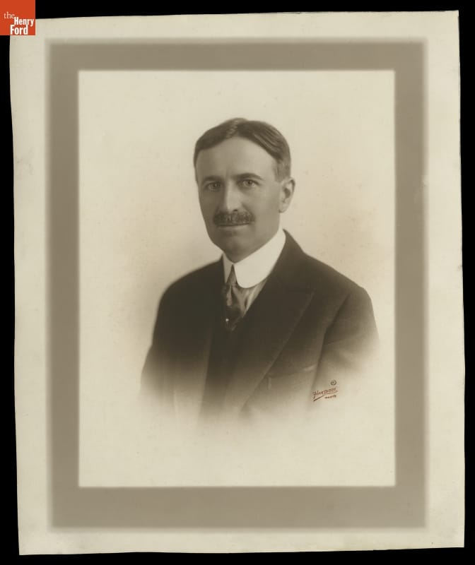 Portrait of man in suit with mustache and hair parted in middle