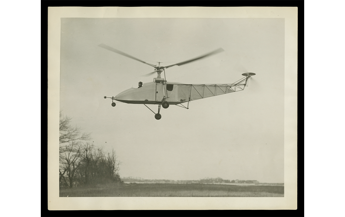 Igor Sikorsky Piloting Vought-Sikorsky Helicopter, Hovering over a Field, circa 1942. / THF125616