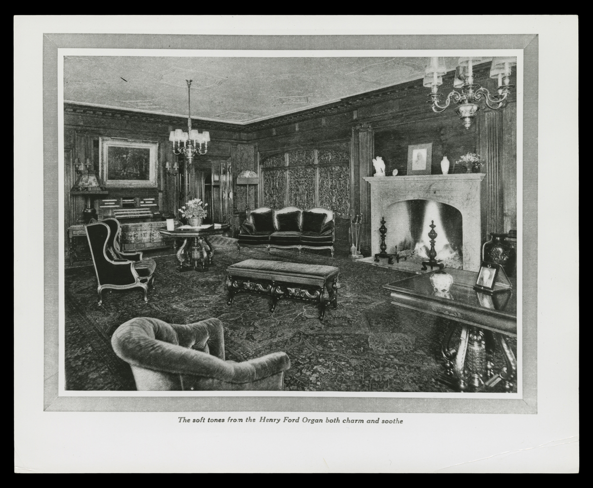 Page with text and photograph or drawing of room interior with carved wood, fireplace, and upholstered furniture