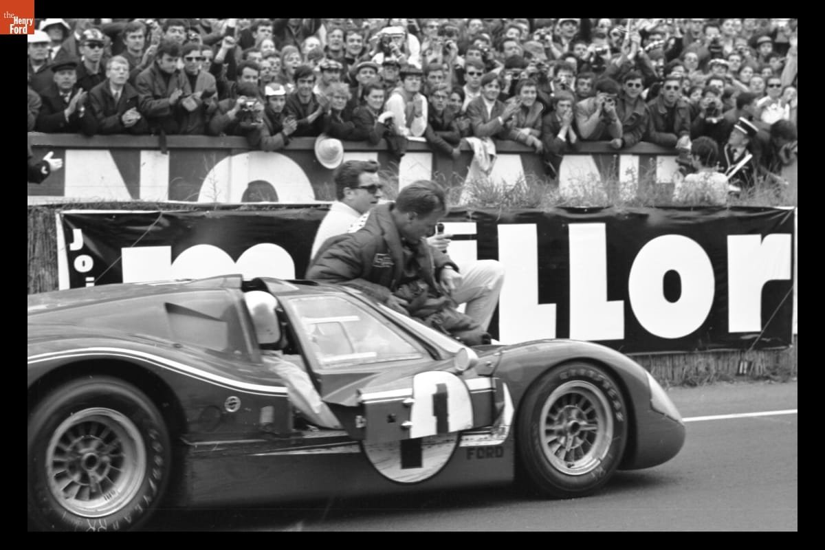 A.J. Foyt driving the #1 Mark IV with Dan Gurney riding the windshield to celebrate their win.