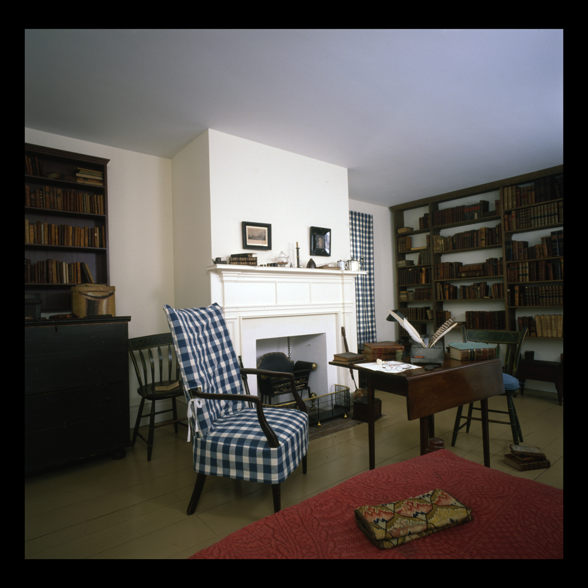 Study inside Noah Webster Home in Greenfield Village, 1989 Room containing bookshelves, armchair, and table and side chairs