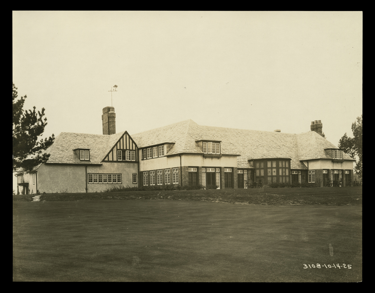 Black-and-white photo of large Tudor-style two-story (?) building