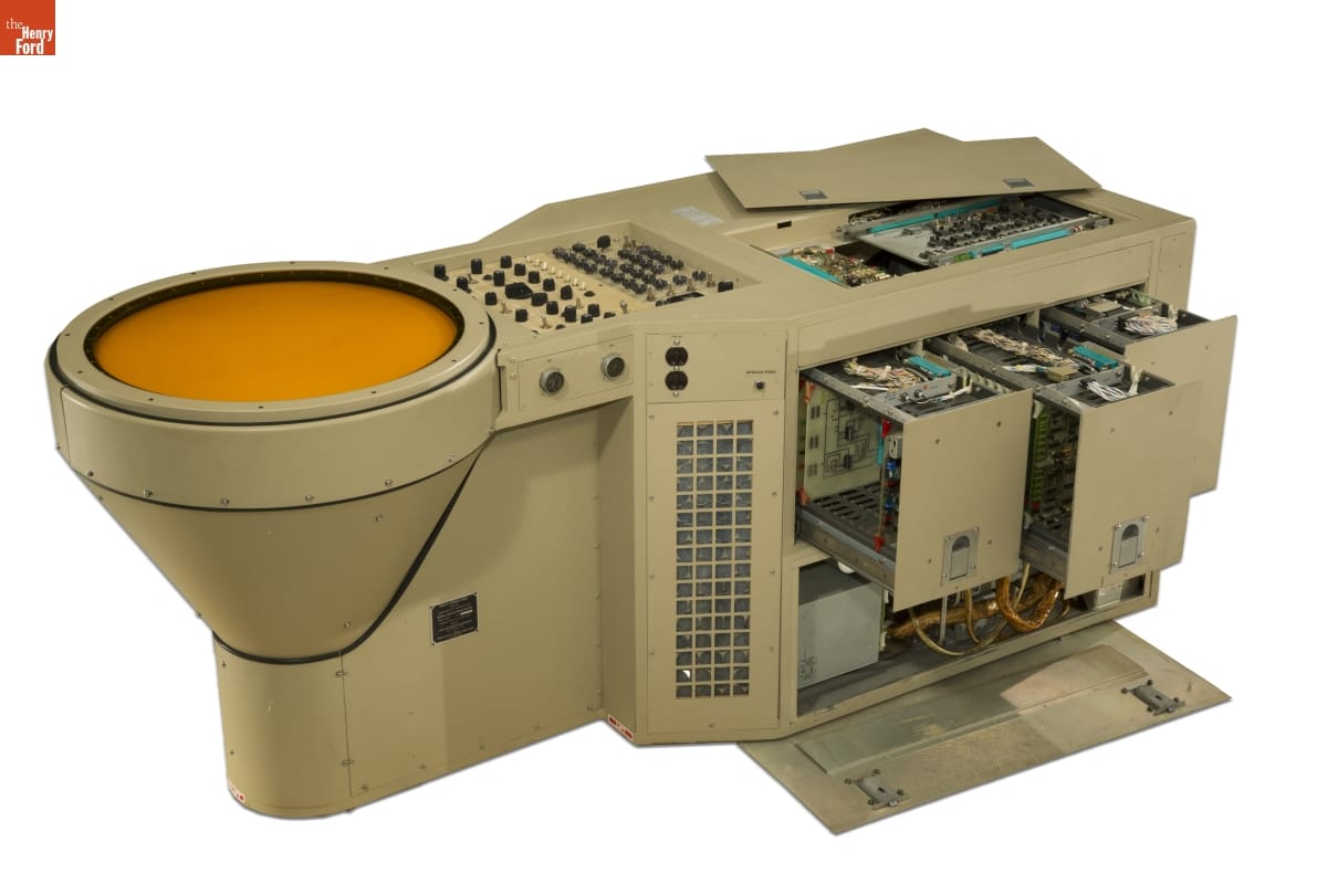 Air Traffic Control Radar Scope, 1969 (open) Large piece of beige metal equipment with round yellow screen (?) at one end and buttons and switches; open panels on top and sides showing complex wiring