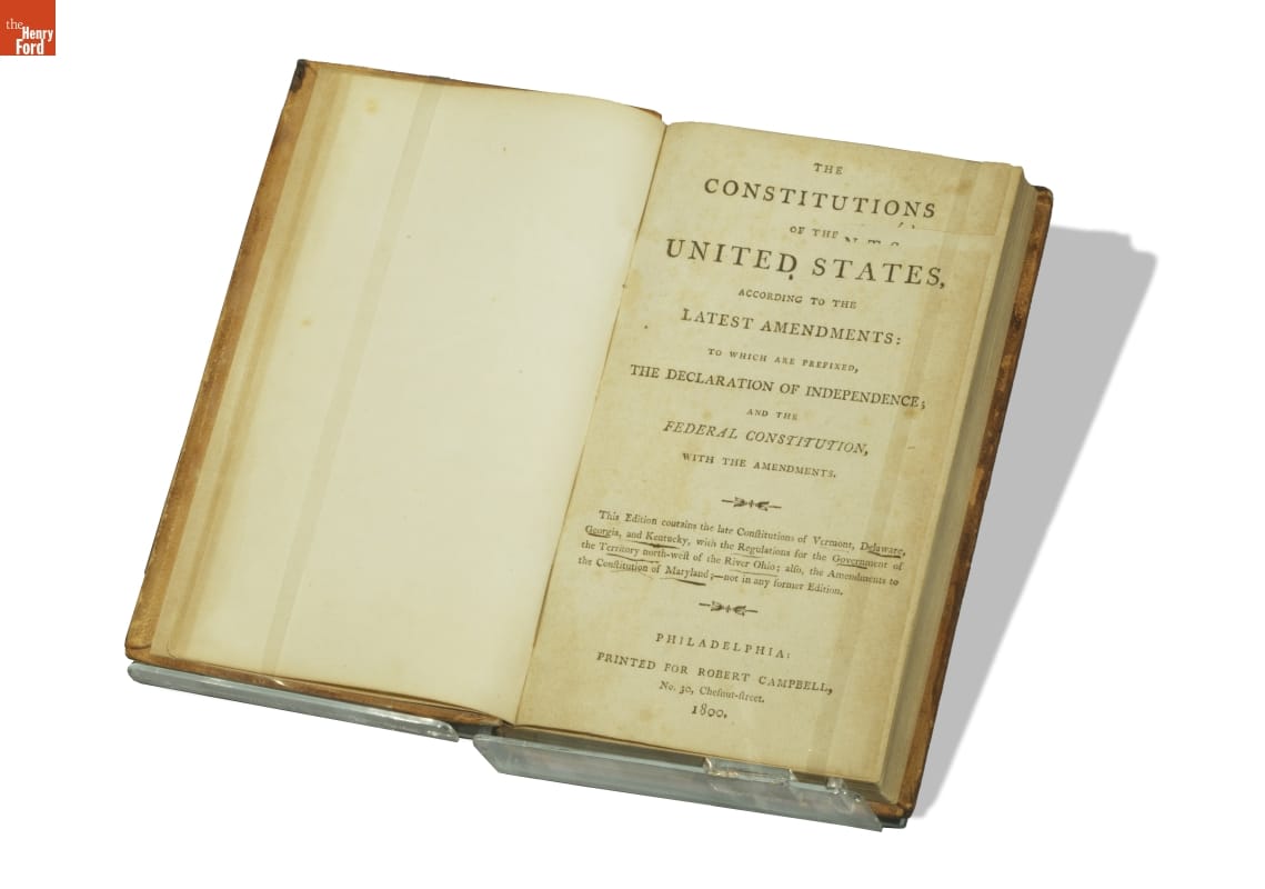 Book opened to title page containing text