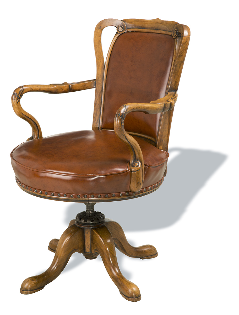 Office Chair, Made 1923, Used by Henry Ford at the Ford Motor Company Engineering Laboratory Brown leather office chair with wooden base, arms, and back edging