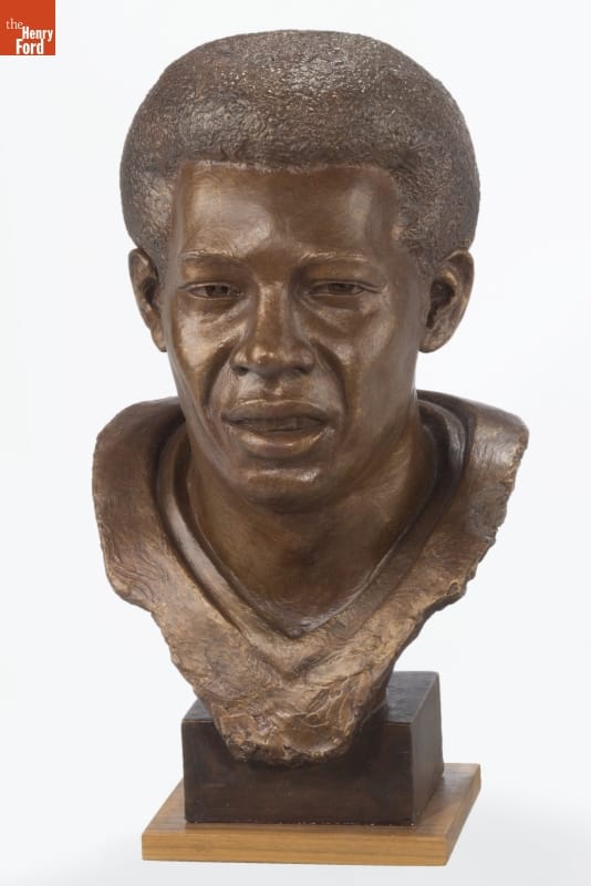 Commemorative Bust of Detroit Lions Tight End, Charlie Sanders, 2007 Sculpture of face and partial torso of man with Afro on square base