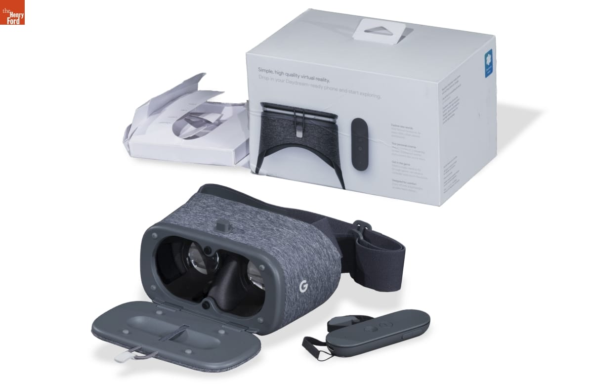 Google Gray fabric-covered goggles with closure, pictured with box and oval-shaped accessory
